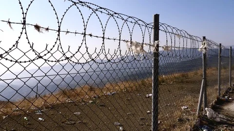 Barbed wire scenery with wind and a lot of rubbish around Stock Footage 119795743