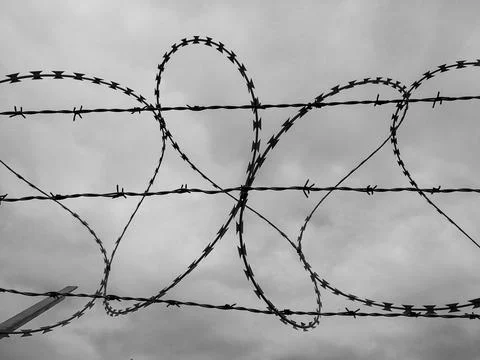 Barbed wire, security fence Stock Photos