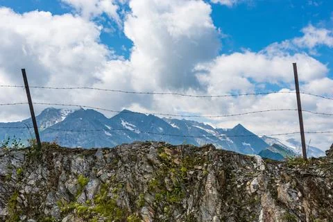 Barbed wire separating the mountain landscape, blue sky Stock Photos
