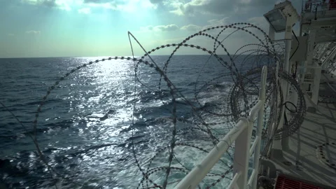 Barbed wire on ship railings. Protection from pirates. Open deck in barbed wire Stock Footage 251541189