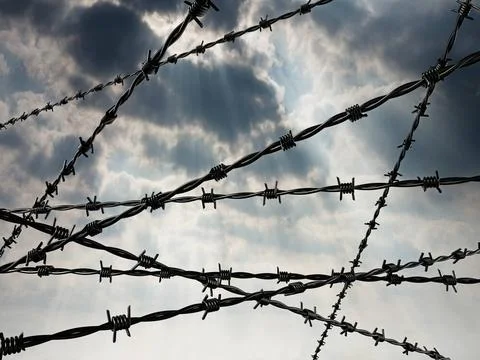 Barbed wired on dark cloudy sky background. 3D illustration Barbed wired o... Stock Photos