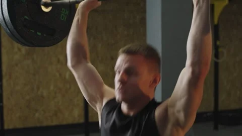 Barbell lifting practice at gym with focus on strength training and technique Stock Footage 331019437