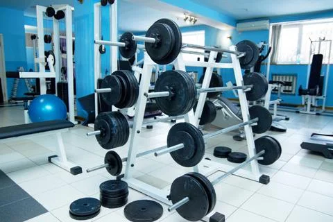 Barbell rack, gym interior and fitness with equipment for wellness, healthy Stock Photos