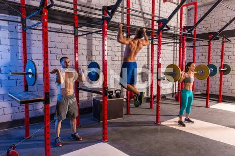 Barbell weight lifting group weightlifting at gym Stock Photos