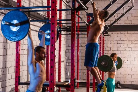 Barbell weight lifting group weightlifting at gym Stock Photos