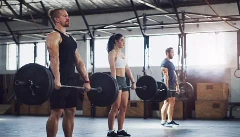 Barbell, workout and class with people in gym for bodybuilder, strength cha.. Stock Photos