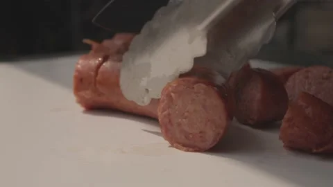 Barbeque BBQ Close Up Knife Cutting Sausage Into Pieces Slow Motion Video stock 205009162