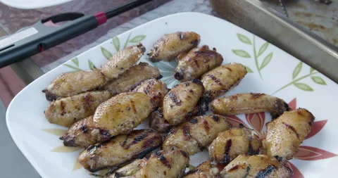 Barbeque chicken wings on the backyard table Stock Footage 131418455