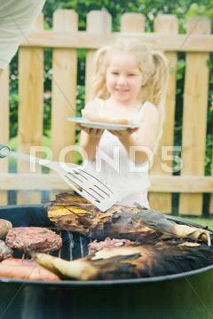 Barbeque: girl waits for hot dog lunch Stock Photos