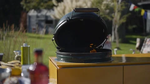 A barbeque grill emits small, dancing flames in an open-air kitchen Stock Footage 247054554
