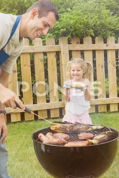 Barbeque: man prepares grilled food Stock Photos
