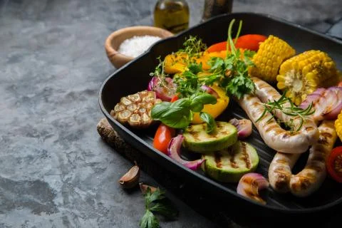 Barbeque sausages with vegetables Stock Photos