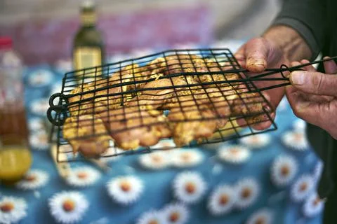 Barbeque. Selective focus on prepared chicken pieces on the wire rack. Blurre Stock Photos