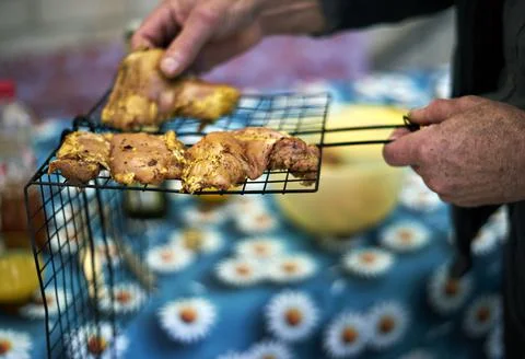 Barbeque. Selective focus on prepared chicken pieces on the wire rack. Blurre Stock Photos