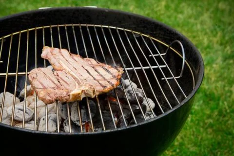 Barbeque: steak done cooking on grill Stock Photos