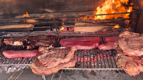 Barbeque with steaks and beef chops on grate  Stock Footage 271290402