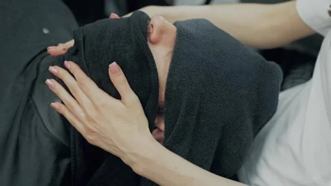 Barber Applying Hot Towel to Client's Face Stock Footage 345586031