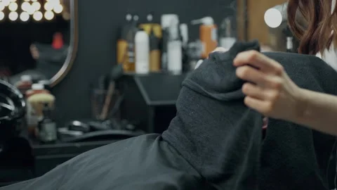 Barber Applying Hot Towel to Client's Face Stock Footage 345586089