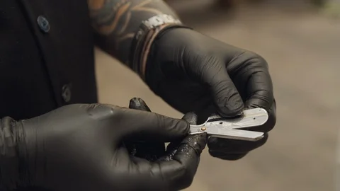 Barber in black gloves is preparing the razor Видео 116889239