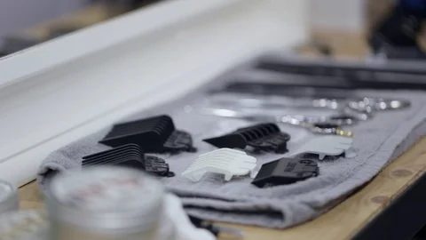 Barber in black gloves takes scissors and comb from a full tool board. Stock Footage 69919361