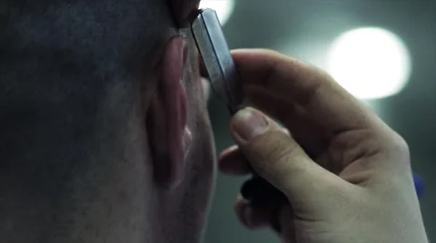 Barber with blade gently corrects hairstyle Stock Footage 61146899