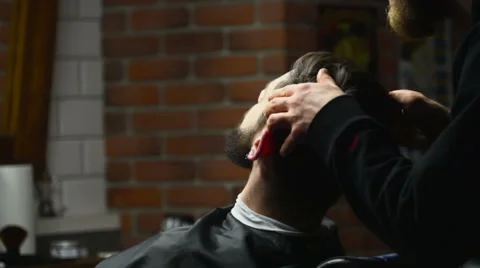 Barber checks his work slow motion Stock Footage 60051030