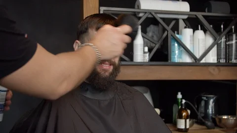 Barber cleaning face of client with neck duster Stock Footage 127175368
