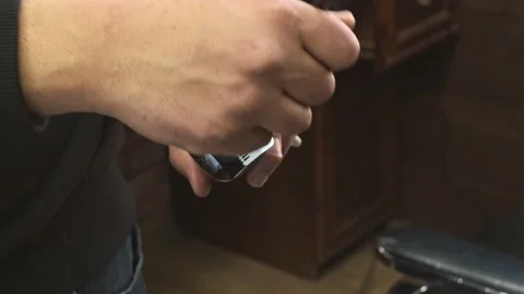 Barber cleans the clipper clipper Stock Footage 154583503