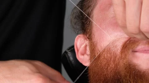 Barber cleans fluff with thread Stock Footage 241030427