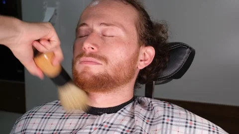 Barber cleans a young man's beard Stock Footage 241030494