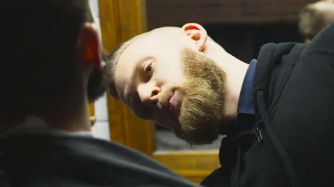 Barber combing customers beard slow motion Stock Footage 60051087