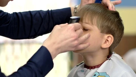 Barber cut bang of the lad with a hair clipper Stock Footage