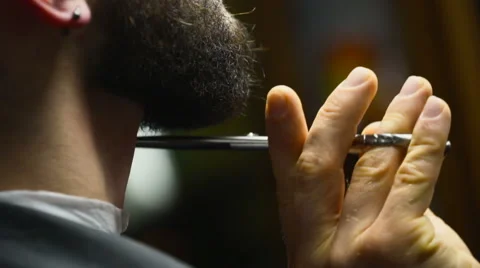 Barber cuts the beard hair of the client with scissors slow motion close up Stock Footage 60051090