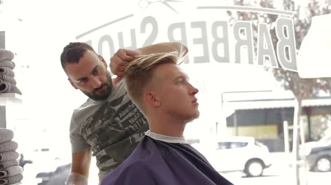 Barber cuts client with scissors in barber shop Stock Footage 68313297