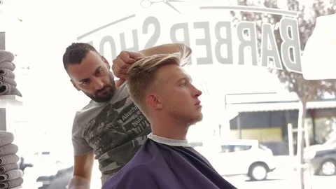 Barber cuts client with scissors in barber shop Stock Footage 69851434