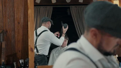 Barber cuts the client with a trimmer. Stock Footage 132284305