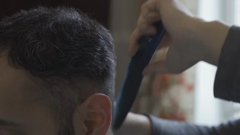 A barber cuts a guy at home at the invitation of a pandemic coronavirus during Stock Footage 130150413