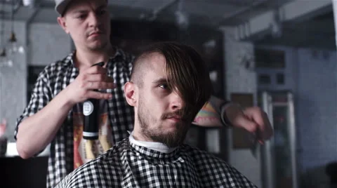 Barber cuts the hair of the client with clipper Stock Footage 62947324