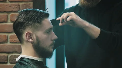 Barber cuts the hair of the client with scissors Stock Footage 46713745