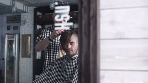 Barber cuts the hair of the client with scissors Stock Footage 62947386