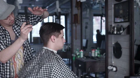 Barber cuts the hair of the client with scissors Stock Footage 62948566