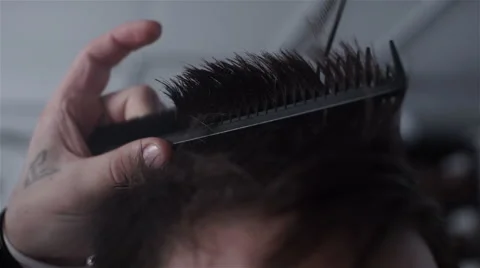 Barber cuts the hair of the client with scissors Stock Footage 62948652