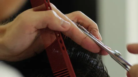 Barber cuts the hair of the client with scissors Stock Footage 63553868