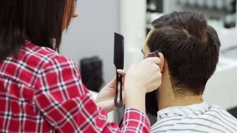 Barber cuts the hair of the client with scissors Stock Footage 70670924