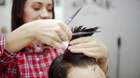 Barber cuts the hair of the client with scissors. Slow motion Stock Footage 70727429