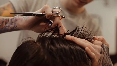 Barber cuts the hair of the client with scissors Stock Footage 85757999
