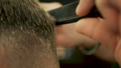 Barber cuts the hair of the client with scissors close-up Stock Footage 102205156