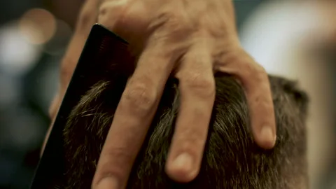Barber cuts the hair of the client with scissors close-up Stock Footage 102205169