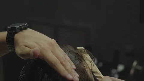 Barber cuts the hair of the client with scissors. Close up. Attractive male is Stock Footage 112605906