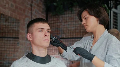 Barber cuts the hair of the client with scissors close-up. Frame. Barber combing Stock Footage 120264673